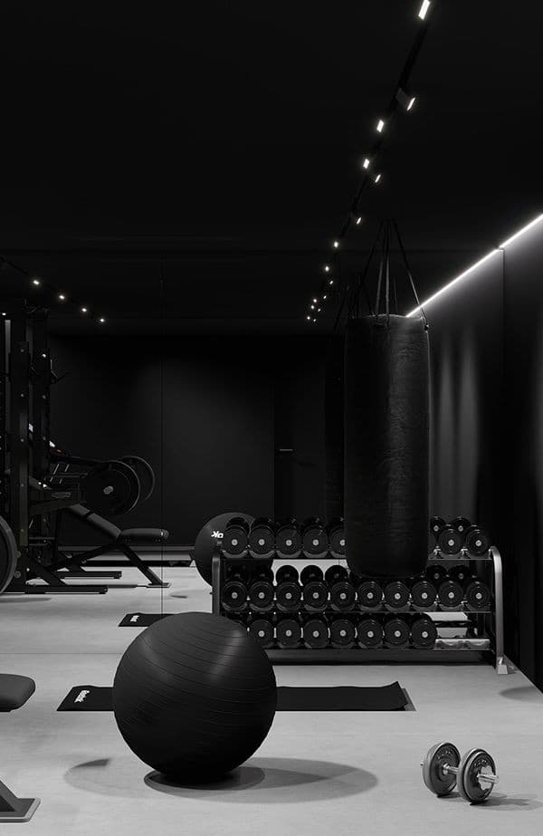 Minimal black gym space with dumbbells and a punching bag