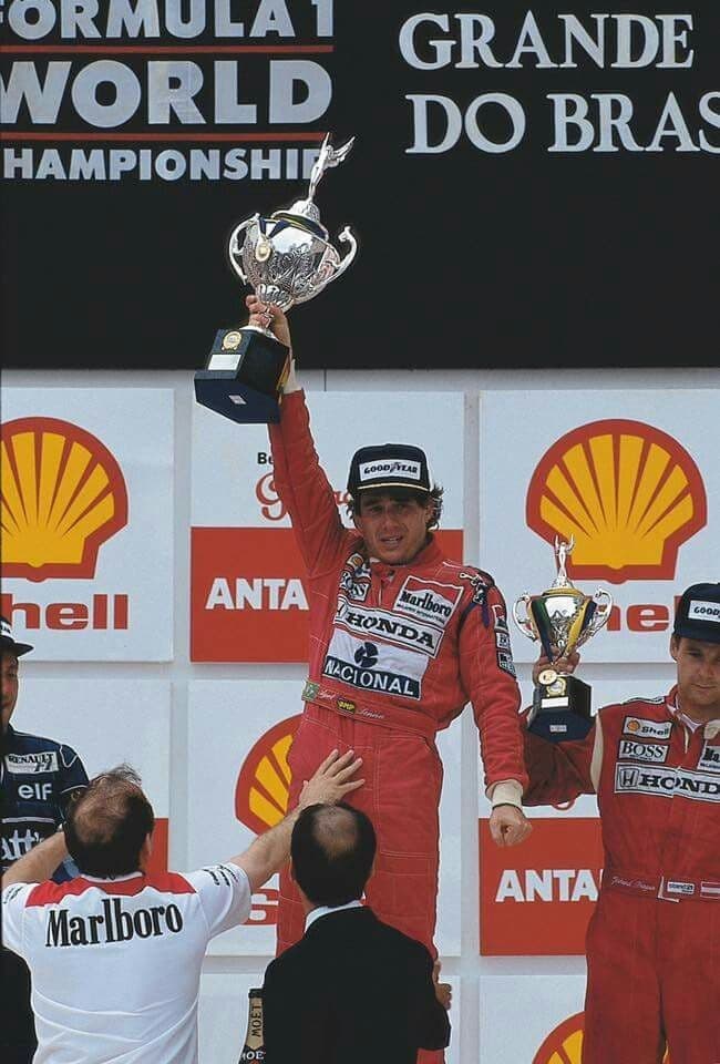 Champion lifting a trophy in front of a podium