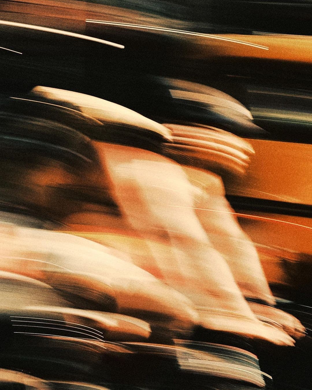 Blurred athletes in motion under warm training lights